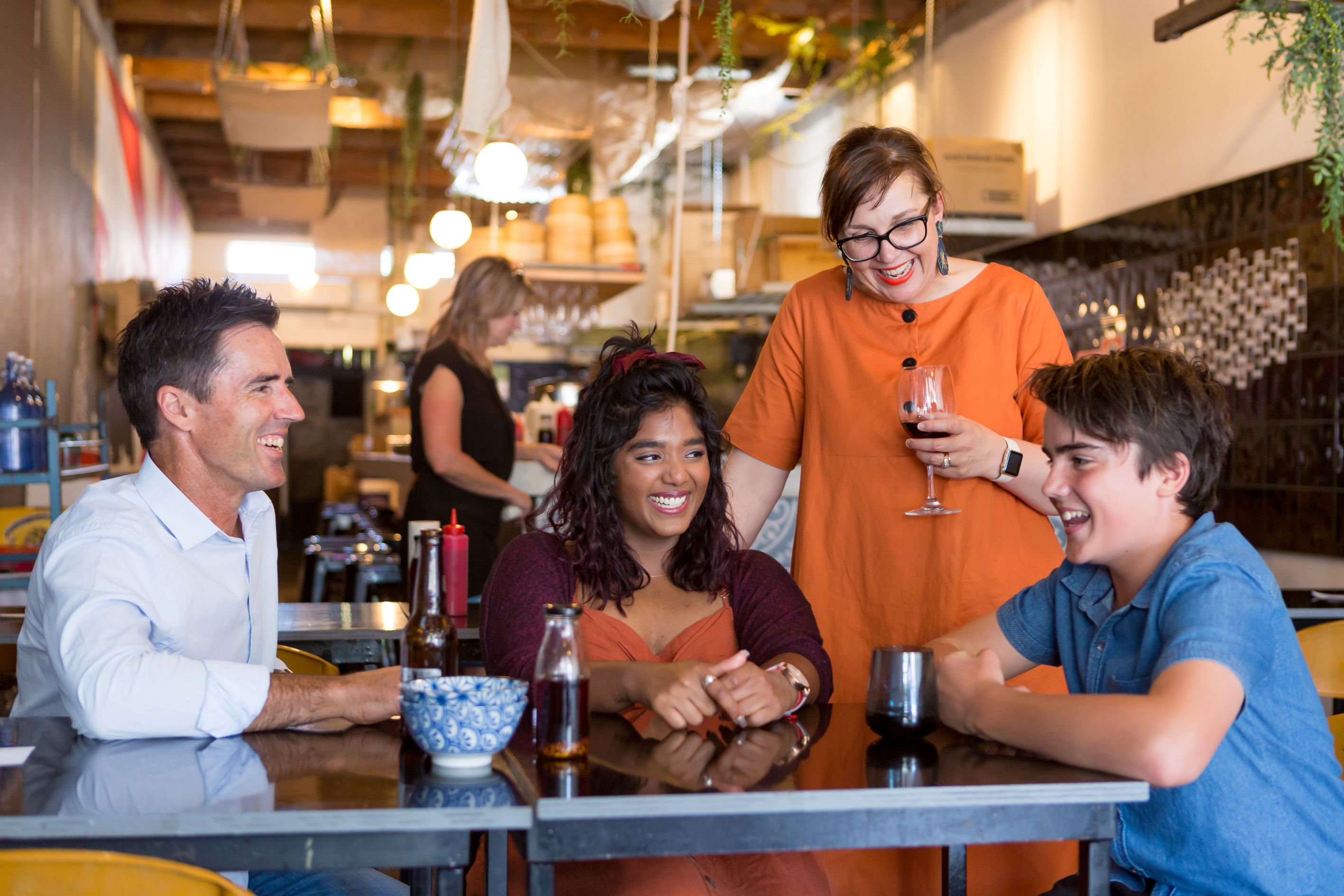 Group of people smiling at a the restaurant Hapi