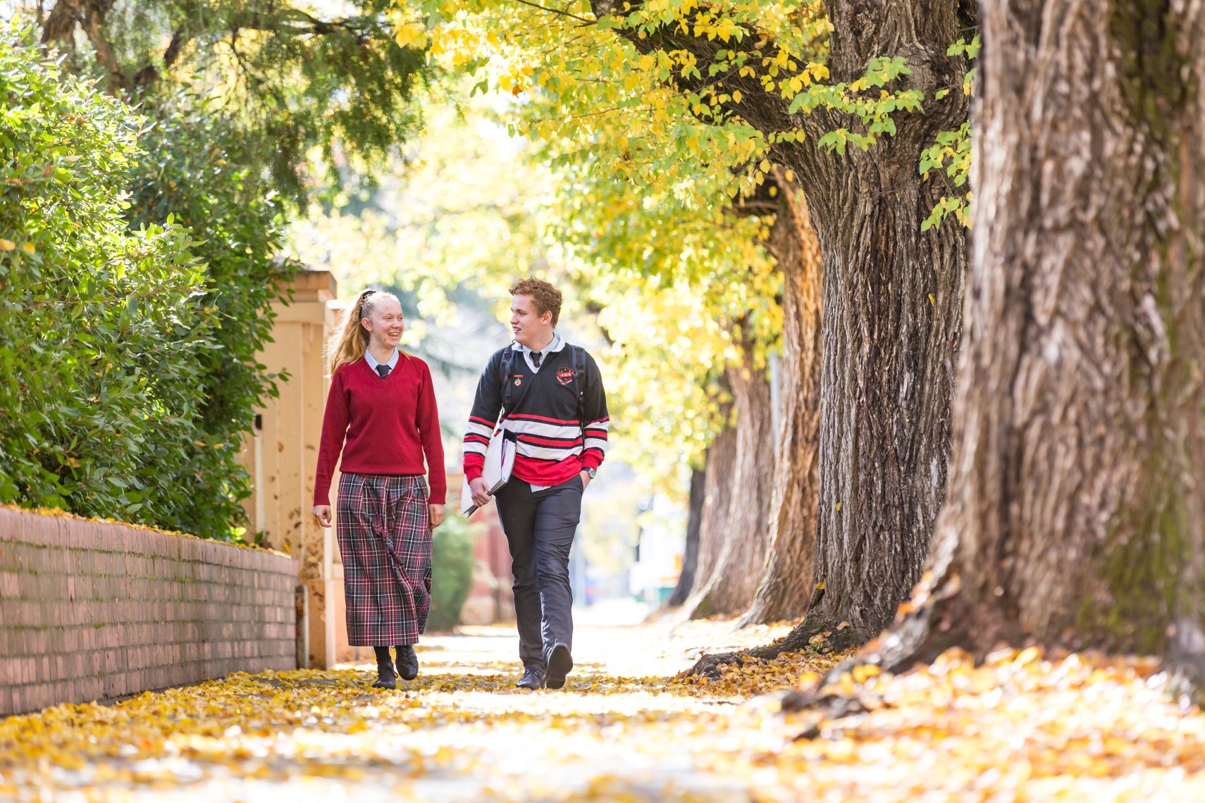 Two students walking down the footpath